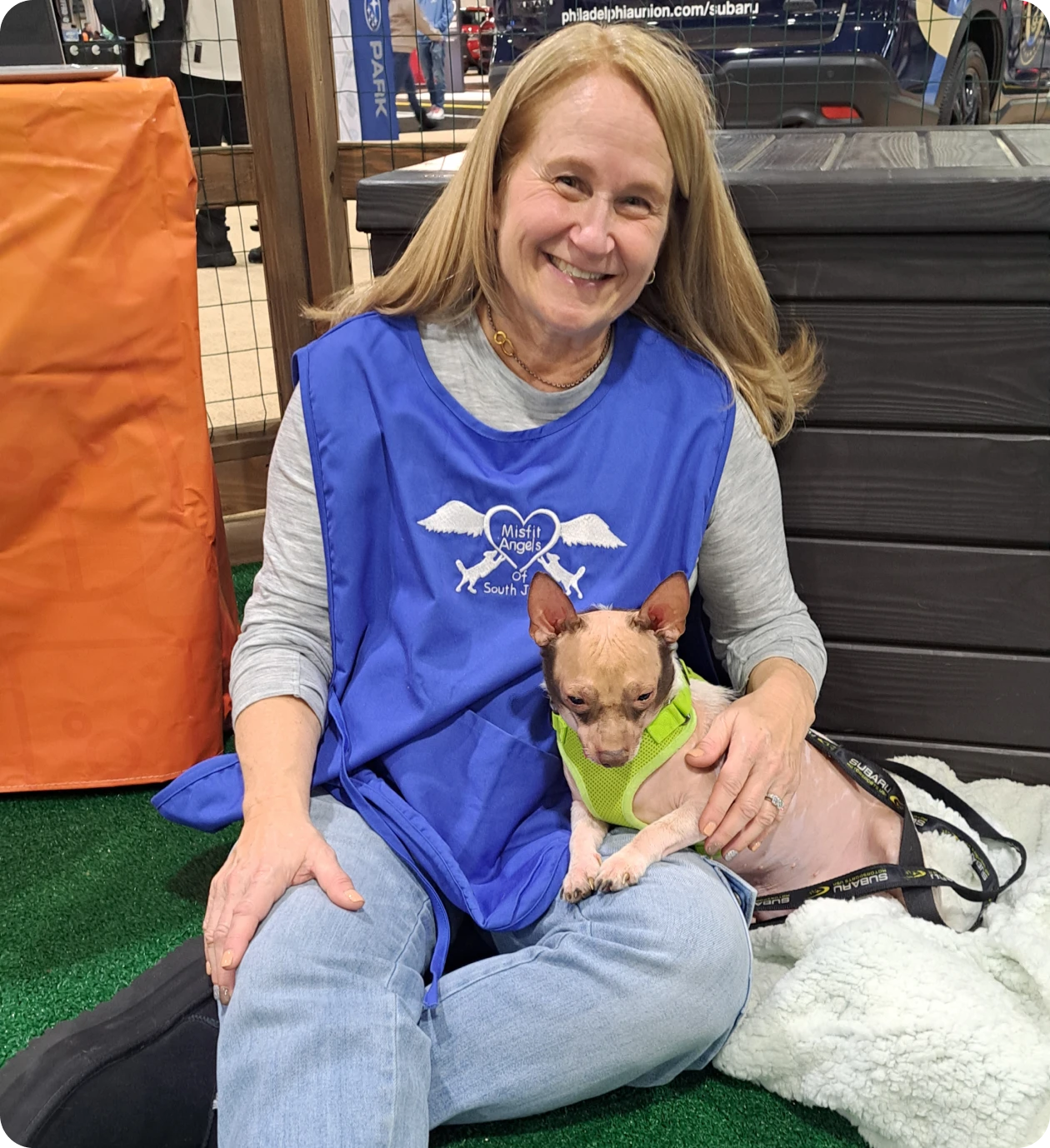 Smiling woman cuddling a Chihuahua